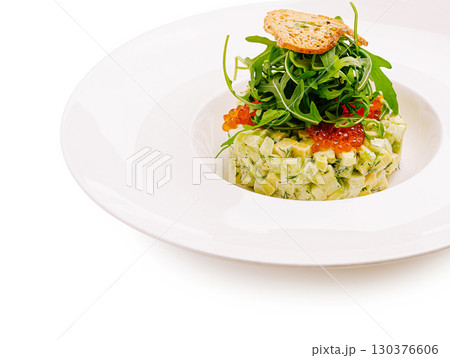 Fresh avocado tartare with herbs and greens served elegantly on a plate Fresh avocado tartare with herbs and greens served elegantly on a plate 130376606