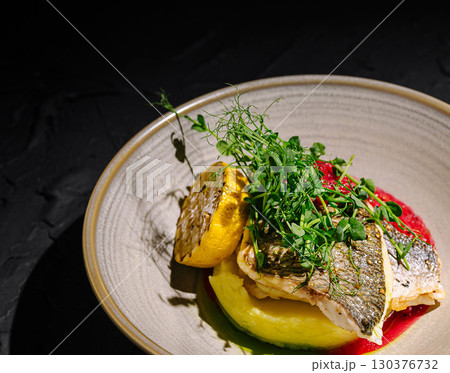 Grilled fish with vibrant veggies and herbs in a chic setting Grilled fish with vibrant veggies and herbs in a chic setting 130376732