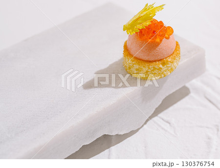 Elegant dessert presented on a marble surface with vibrant toppings 130376754