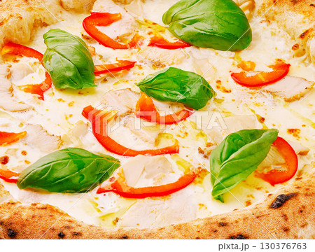Delicious pizza topped with chicken, red peppers, and fresh basil Delicious pizza topped with chicken, red peppers, and fresh basil 130376763