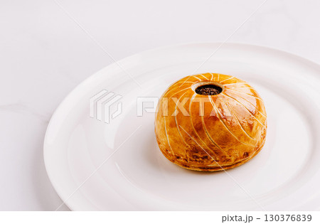 Delicious pastry dessert placed on a white plate for a sweet delight Delicious pastry dessert placed on a white plate for a sweet delight 130376839