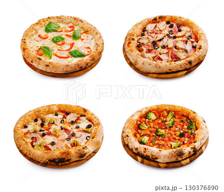 Freshly baked pizzas with assorted toppings on wooden plates 130376890