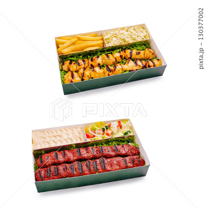 Grilled chicken skewers with fries and coleslaw served in a take Grilled chicken skewers with fries and coleslaw served in a take 130377002