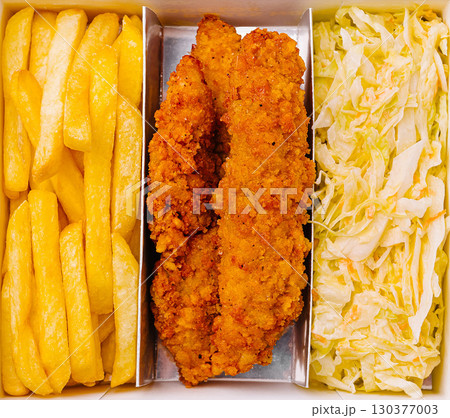 Crispy chicken strips with golden fries and fresh cabbage slaw served in a box Crispy chicken strips with golden fries and fresh cabbage slaw served in a box 130377003