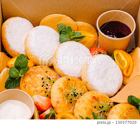 Delicious dessert selection with fruits and creamy toppings arranged beautifully Delicious dessert selection with fruits and creamy toppings arranged beautifully 130377020