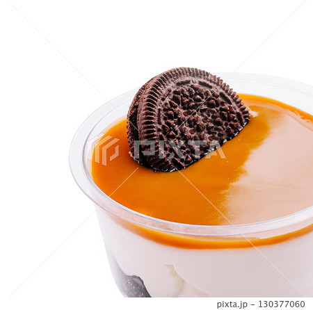 Dessert with caramel sauce and chocolate cookie topping served in a cup Dessert with caramel sauce and chocolate cookie topping served in a cup 130377060