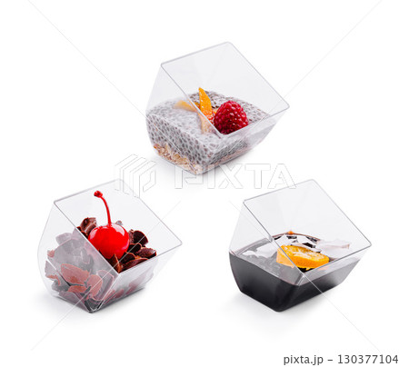 Unique dessert cups filled with colorful treats display in a kitchen setting 130377104