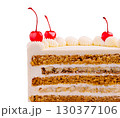 Delicious layered cake topped with cherries and creamy frosting 130377106