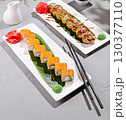 Sushi platter with vibrant rolls and garnishes in a calm setting 130377110