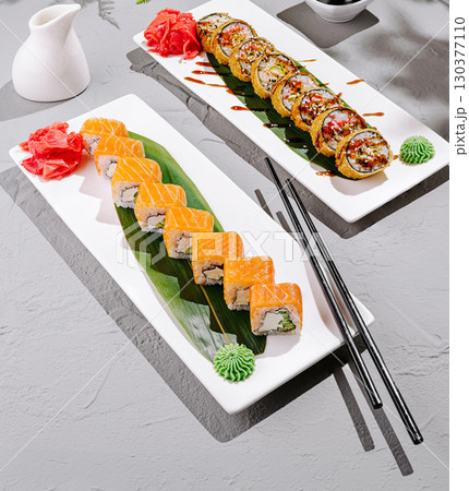 Sushi platter with vibrant rolls and garnishes in a calm setting 130377110