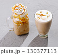 Two coffee beverages are presented on a textured surface 130377113