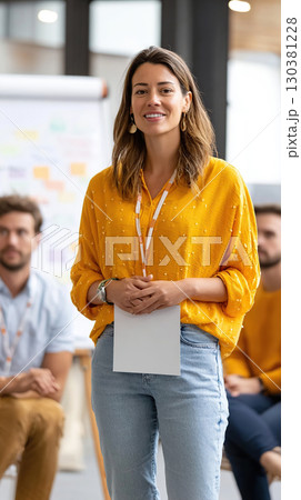 Team member delivers a presentation in a collaborative workspace during a team meeting 130381228