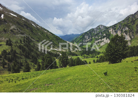 Distant sunny mountain valley. Summertime. 130381824