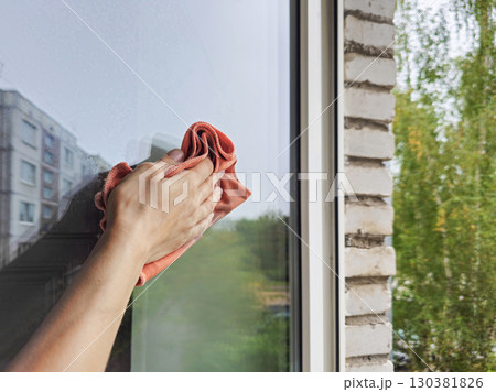 cleaning the windows with a cotton rag cleaning the windows with a cotton rag 130381826