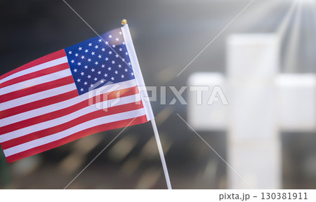 Small American flags and headstones. Memorial Day display. American flag flag on grave. United States National flag with tombstone cross on Memorial Day. 130381911