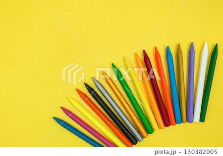 Top view of Colorful Crayon pencils. Close up set of crayons mix color. Colorful wax crayons isolated on yellow background. clipping path. Background for back to school concept. 130382005