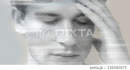A man with closed eyes expresses distress, holding his forehead in a moment of pain and discomfort 130382073
