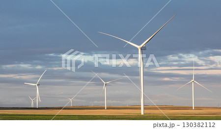 Wind turbine generators for sustainable electrical energy production. Panoramic view of windmills in a rural area during sunset. Sustainable , renewable energy green technology industry 130382112