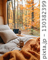 Cozy autumn morning with coffee in a cabin surrounded by colorful foliage 130382399