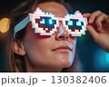 Person wearing neon virtual reality glasses gazing intently at a digital landscape at night 130382406