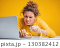 Frustration from computer issues while working at a desk with a bright yellow background 130382412