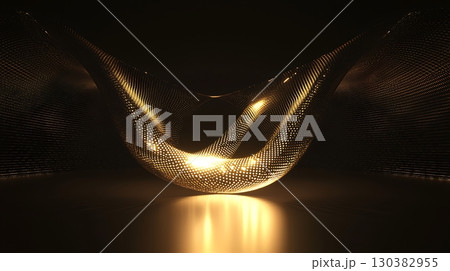 A gold object with a curved shape is lit up in a dark room 130382955