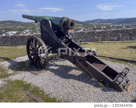 Trencin, Slovakia - August 28, 2025: Medieval cannon under walls of the ancient castle Trencin in Slovakia from the 11th century. 130383456