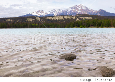Scenic view to cyan cold waters of the mountain lake. Scenic view to cyan cold waters of the mountain lake. 130383742