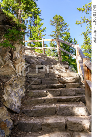 Rocky steps with rails in the steep mountain hiking trail. Rocky steps with rails in the steep mountain hiking trail. 130383749