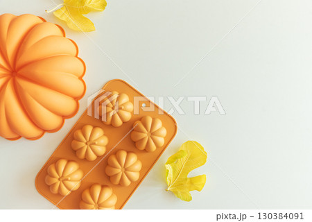 Autumn Baking Setup with Pumpkin Mold, Frosting and Seasonal Decorations Autumn Baking Setup with Pumpkin Mold, Frosting and Seasonal Decorations 130384091