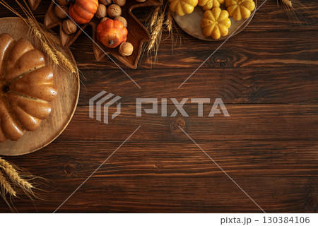 Autumn Harvest Table with Bundt Cake, Pumpkin Cookies and Seasonal Decor 130384106