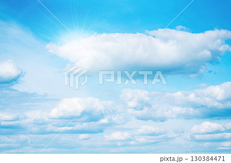 Bright blue sky with white clouds and sunlight 130384471