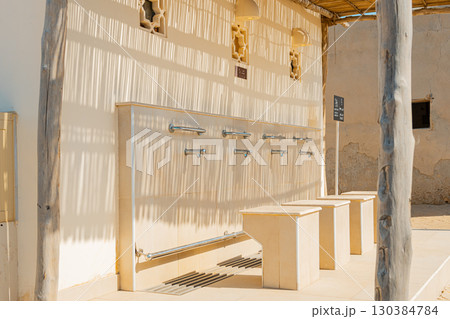 Ras Al Khaimah, UAE – 14.04.2025: The desert coastal town (ghost town) of Jazeera Al Hamra includes a fort, three schools, an open-air market and mosques nestled between hundreds of villas . High Ras Al Khaimah, UAE – 14.04.2025: The desert coastal town (ghost town) of Jazeera Al Hamra includes a fort, three schools, an open-air market and mosques nestled between hundreds of villas . High 130384784