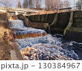 A large body of water with a bridge in the background. 130384967
