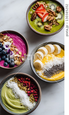Colorful smoothie bowls arranged in an artistic flat lay for healthy eating 130385202
