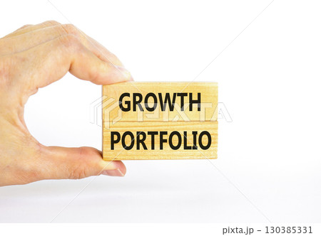 Growth portfolio symbol. Concept words Growth portfolio on beautiful wooden block. Beautiful white paper background. Businessman hand. Business Growth portfolio concept. Copy space. 130385331
