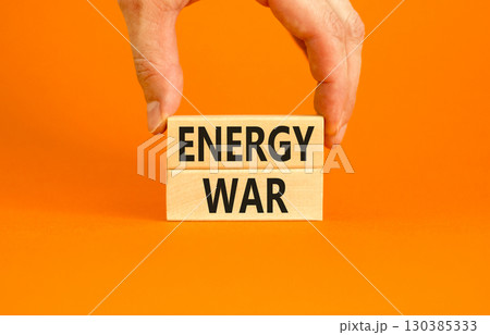 Energy war symbol. Concept words Energy war on beautiful wooden block. Beautiful orange table orange background. Businessman hand. Business and Energy war concept. Copy space. 130385333