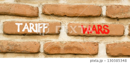 Trade tariff wars symbol. Concept word Tariff wars on beautiful old brown brick wall. Beautiful old brown brick wall background. Old brick wall. Business trade tariff wars concept. Copy space. 130385348
