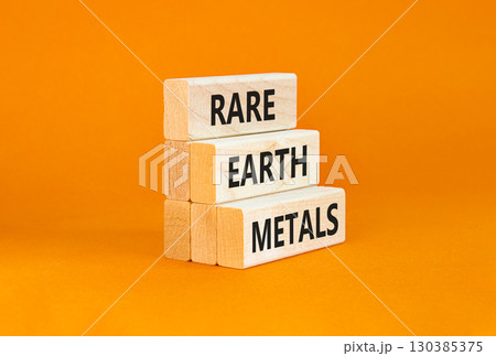 Rare earth metals symbol. Concept words Rare earth metals on beautiful wooden block. Beautiful orange table orange background. Business and rare earth metals concept. Copy space. 130385375