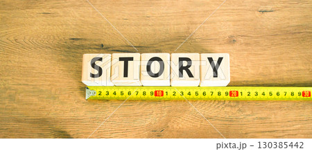 Story symbol. Concept word Story on beautiful wooden blocks. Beautiful wooden table wooden background. Beautiful yellow ruler. Business lifestyle story concept. Copy space. Story symbol. Concept word Story on beautiful wooden blocks. Beautiful wooden table wooden background. Beautiful yellow ruler. Business lifestyle story concept. Copy space. 130385442