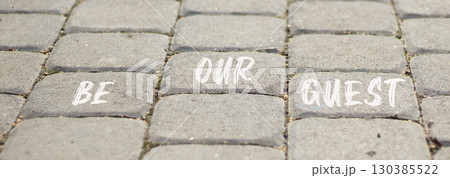 Be our guest symbol. Concept words Be our guest on beautiful grey road break. Beautiful grey road break background. Business and be our guest concept. Copy space. Be our guest symbol. Concept words Be our guest on beautiful grey road break. Beautiful grey road break background. Business and be our guest concept. Copy space. 130385522