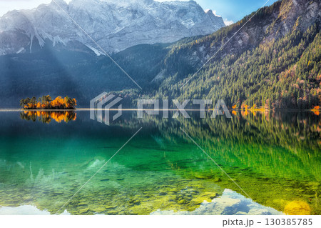 Amazing autumn landscape of Eibsee Lake in front of Zugspitze summit under sunlight. 130385785
