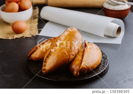 Freshly baked Ukrainian pies on rustic background, homemade traditional pastries, heritage food Freshly baked Ukrainian pies on rustic background, homemade traditional pastries, heritage food 130386305