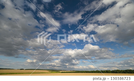 The Beautiful Cloudy Skies Gracefully Stretch Over the Expansive Open Fields Below 130386723