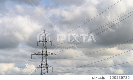 The image shows Power Lines Against a Cloudy Sky, highlighting the dramatic atmosphere 130386726