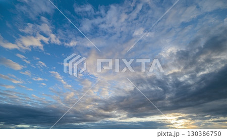 Incredible Dramatic Sky with Unique Cloud Patterns Illuminated at Sunset During Twilight Incredible Dramatic Sky with Unique Cloud Patterns Illuminated at Sunset During Twilight 130386750