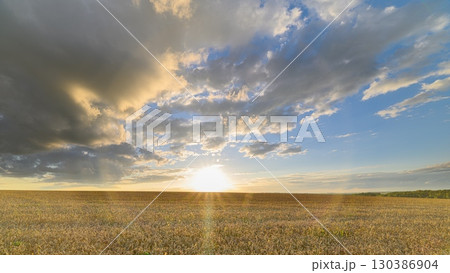 A Beautiful Sunset Over a wheat Field Creating a Magical and Tranquil Atmosphere A Beautiful Sunset Over a wheat Field Creating a Magical and Tranquil Atmosphere 130386904
