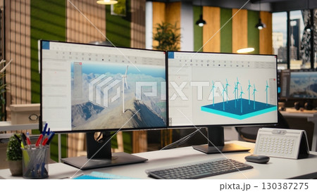Wind turbine simulation on PC screens in research and development office. CAD software on computer monitors supporting renewable energy engineering and sustainable technology innovation 130387275