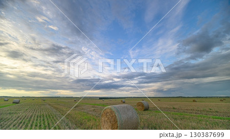 A Beautiful and Scenic Agricultural Landscape Filled with Bales Under a Dramatic Sky A Beautiful and Scenic Agricultural Landscape Filled with Bales Under a Dramatic Sky 130387699