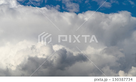 A Dramatic Cloudscape Overhead Accompanied by a Beautiful and Vivid Blue Sky Above A Dramatic Cloudscape Overhead Accompanied by a Beautiful and Vivid Blue Sky Above 130387734